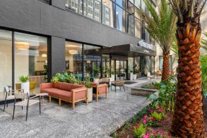 a lobby of a building with chairs and palm trees at Element by Marriott New Orleans Downtown in New Orleans