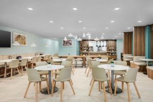 a restaurant with tables and chairs and a kitchen at Element by Marriott New Orleans Downtown in New Orleans