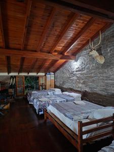 a row of beds in a room with a brick wall at Cabañas Lodge Angirú in Goya +71 photos