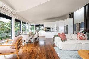 a living room with a white couch and a table at Mysa Homestead in Tonimbuc