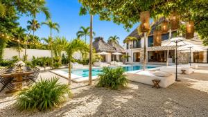 an exterior view of a resort with a swimming pool at Villa Luxauthentika Tulum in Tulum