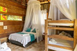 a bedroom with two bunk beds in a cabin at Magic Green Dentro del Parque Tayrona in El Zaino +53 photos