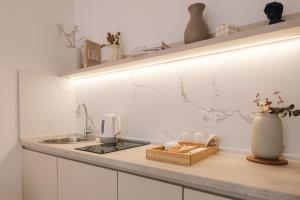 a white kitchen with a sink and a counter top at NUA Apartments in Ulcinj