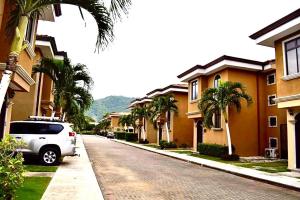 a white van parked on a street next to houses at Casa Arrecifes in Coco