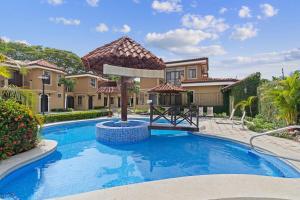 a villa with a swimming pool and a house at Casa Arrecifes in Coco