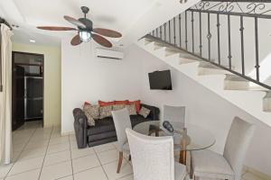 a living room with a couch and a table at Casa Arrecifes in Coco