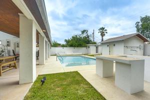 a backyard with a swimming pool and a house at Centrally Located Eagle Pass Home w/ Pool! in Eagle Pass