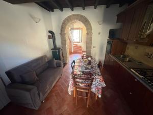 a living room with a table and a couch at Casina Ghiana in Zocca +10 photos