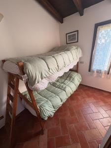 a bedroom with two bunk beds in a room at Casina Ghiana in Zocca