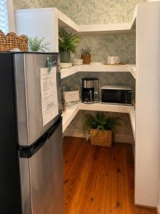 a kitchen with a stainless steel refrigerator and cabinets at Inn on Turner in Oriental