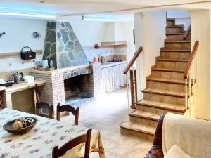 a living room with a fireplace and a table at Villa Nadimar - Casa rural con terraza magnífica y 4 habitaciones in Benecid
