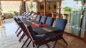 a wooden table with chairs around it in a room at Bungalow 21 Tauro in La Playa de Tauro