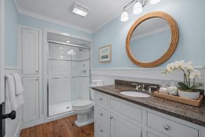 a bathroom with a toilet and a sink and a mirror at Inn on Turner in Oriental