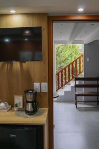 a kitchen with a blender on a counter and a staircase at Casinha de Aldeia in Aldeia Velha +31 photos
