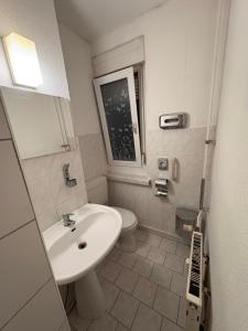 a bathroom with a sink and a toilet at Pension Reiter in Berlin +53 photos