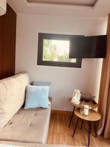 a living room with a couch and a window at Zakątek Młynarza in Pruszkowo