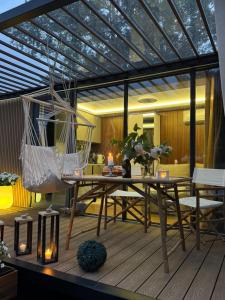 a patio with a hammock and a table and chairs at Zakątek Młynarza in Pruszkowo
