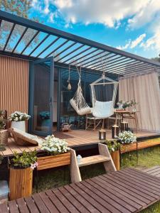 a patio with a swing and a hammock at Zakątek Młynarza in Pruszkowo