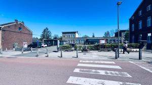 an empty street with a crosswalk in a city at Le refuge de Boncelles in Seraing