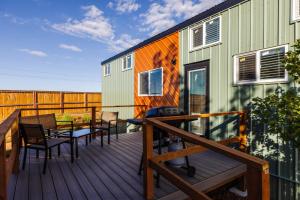 a deck with a table and chairs and a house at Zion Family Adventure Hub Hiking MTB in Apple Valley +43 photos