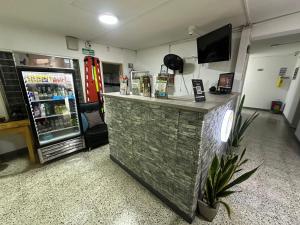 a bar in a store with a refrigerator at hotel guayacanes central in Medellín