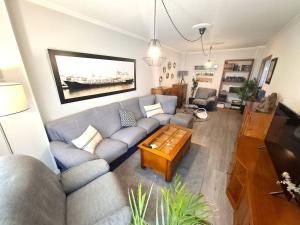 a living room with a couch and a coffee table at Dúplex 4 dormitorios Playa Foz in Foz