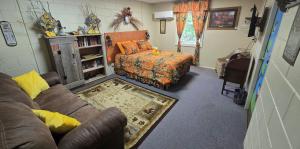 a living room with a couch and a chair at Medley Manor in East Peoria