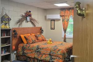 a bedroom with a bed with a rubber duck on it at Medley Manor in East Peoria