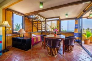 a bedroom with a bed and a table and chairs at Hotel Casamar Suites in Puerto Escondido