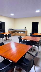 a classroom with tables and chairs in a room at Hotel Rocha in Novo Acordo +7 photos