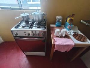 a kitchen with a stove with pots and pans on it at Chepe de mi Corazon in Abancay
