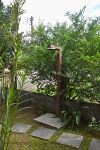 a street light next to a stone wall at Casinha de Aldeia in Aldeia Velha
