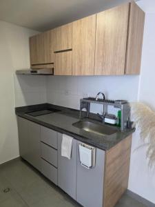 a kitchen with a sink and a counter top at Cozy studio apartment with a privileged view in Manizales +8 photos