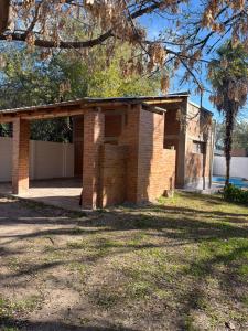 a brick house with a garage in a yard at Graciela in Villa Las Rosas