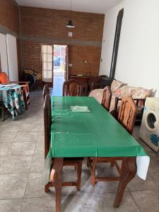 a green table and chairs in a living room at Graciela in Villa Las Rosas +6 photos