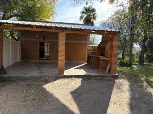 a small brick house with a large deck at Graciela in Villa Las Rosas
