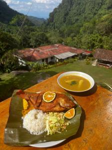 a plate of food with rice and a bowl of soup at Ecohotel Bellavista Pance in Cali