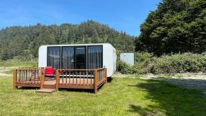 a trailer sitting in the grass in a field at Blackcomb Apple Pod in Klamath