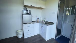 a small kitchen with a sink and a microwave at Blackcomb Apple Pod in Klamath