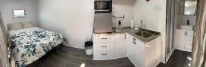 a small bedroom with a bed and a sink at Blackcomb Apple Pod in Klamath