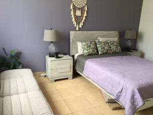 a bedroom with a bed and a night stand and a couch at Paradizio in Coco +37 photos