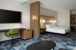 a hotel room with a bed and a flat screen tv at Fairfield by Marriott Inn & Suites Corbin in Corbin +54 photos