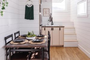 a kitchen with a table and chairs in a tiny house at Zion Family Adventure Hub Hiking MTB in Apple Valley
