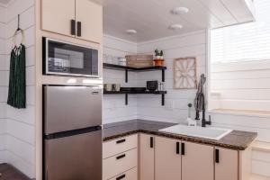 a kitchen with a stainless steel refrigerator and a sink at Zion Family Adventure Hub Hiking MTB in Apple Valley