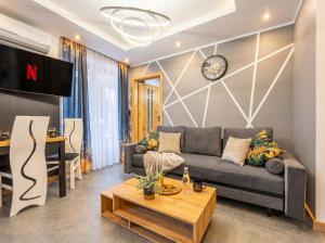 a living room with a couch and a table at Golden Apartments - Tatra View - Księżycowe Apartamenty SPA - 24d-1 in Zakopane