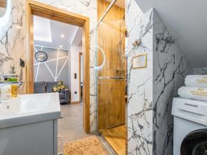 a bathroom with a shower and a sink at Golden Apartments - Tatra View - Księżycowe Apartamenty SPA - 24d-1 in Zakopane +43 photos