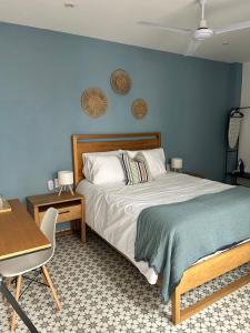 a bedroom with a bed with a blue wall at Casa Andres in Guadalajara