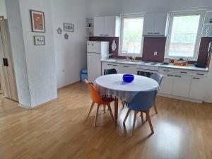 a kitchen with a table and chairs in a room at Atelier22 in Prilep