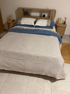 a bedroom with a large bed with blue sheets at tud dret in Santa Maria +34 photos