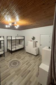 a room with two bunk beds and a wooden ceiling at Hub 1001 Berat Hostel in Berat